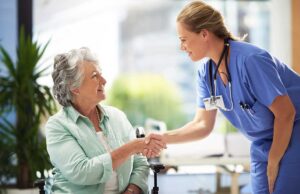 Older adult and family member reviewing a care plan at a dining table with a caregiver nearby.